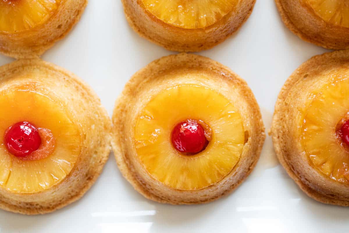 Top view of pineapple and cherry topped cupcakes.