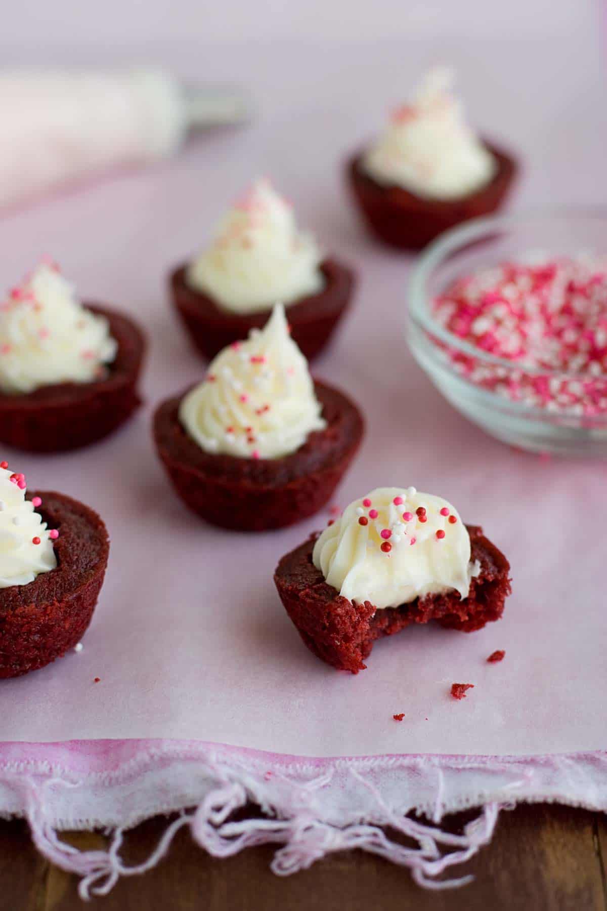 Red Velvet Brownie Cups with a bite taken from one of them.
