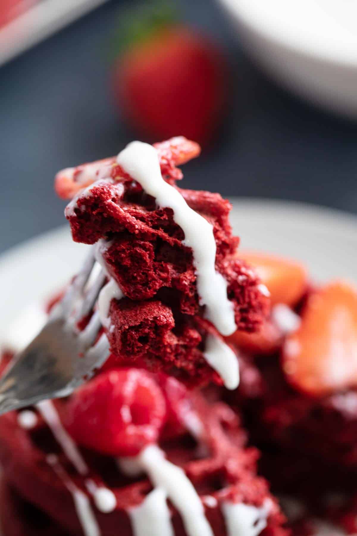 Fork full of red velvet waffles.