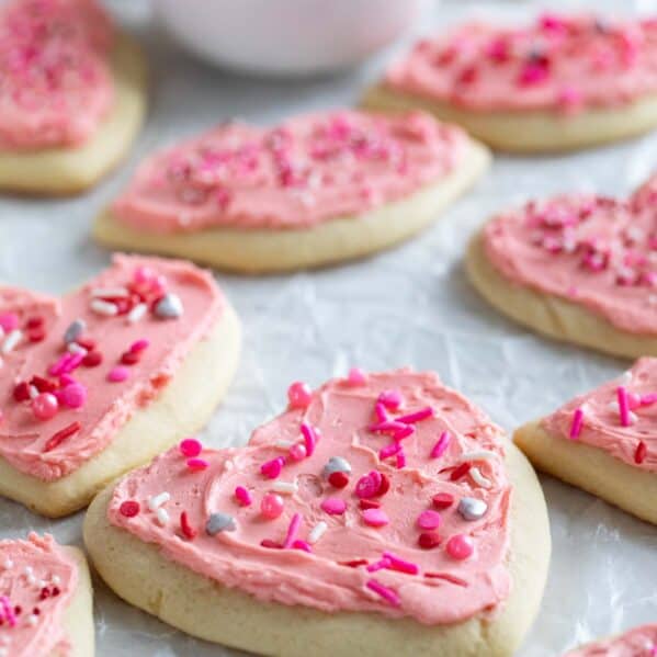 Shaped Valentine's day sugar cookies with pink buttercream frosting.