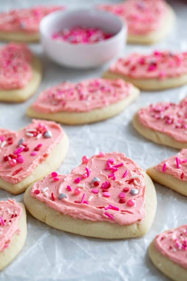 Shaped Valentine's day sugar cookies with pink buttercream frosting.