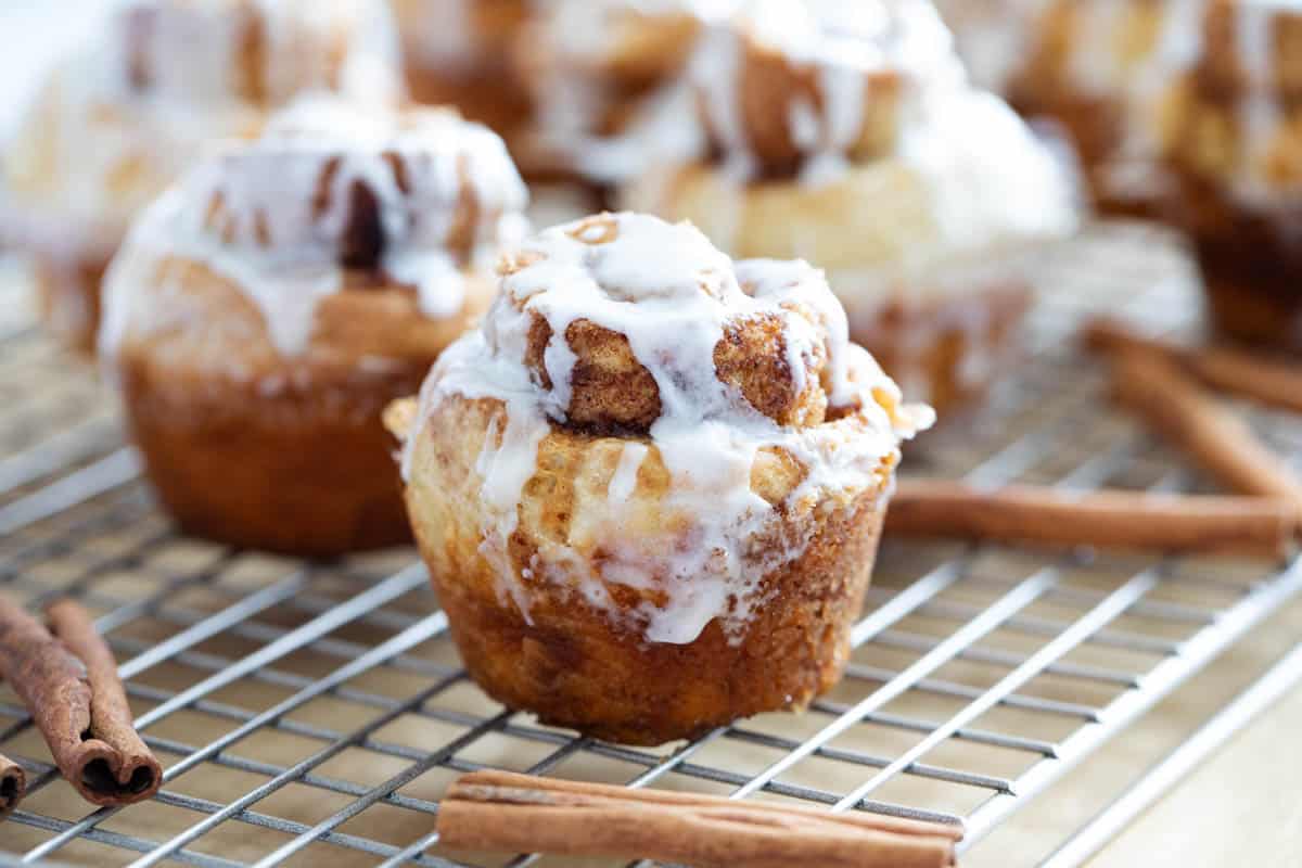Cinnamon roll muffins topped with glaze.