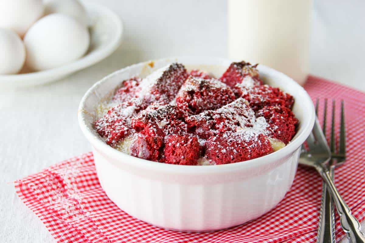 Serving of red velvet bread pudding in a white ramekin.