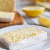 Slice of iced Lemon Loaf on a plate.