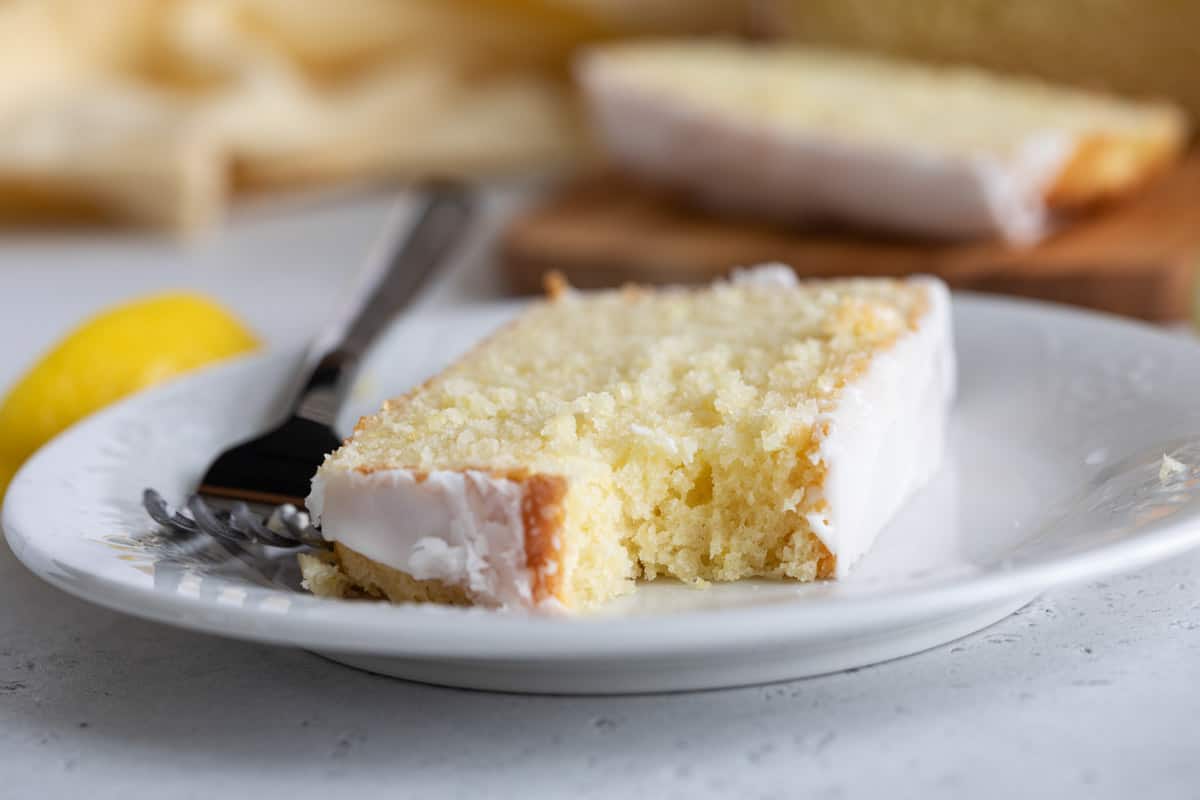 Slice of lemon loaf with a bite taken from it.