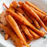 Oven roasted carrots topped with thyme.