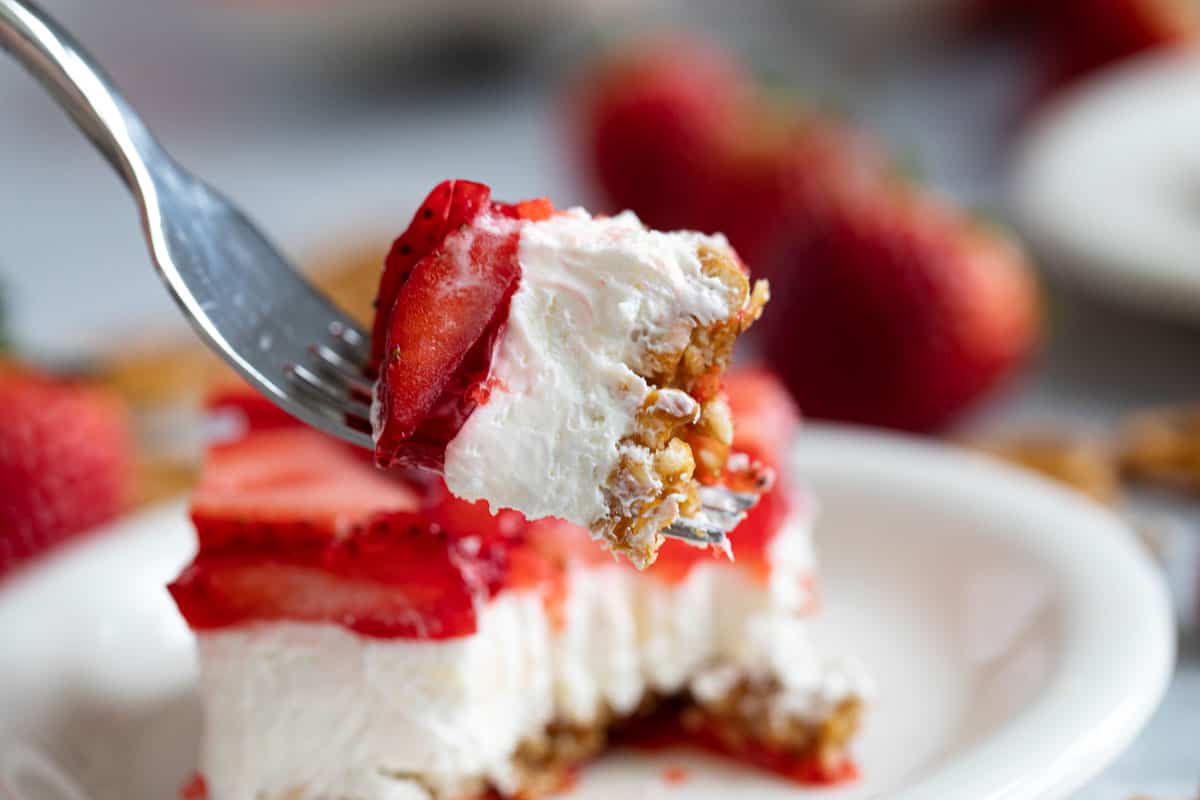 Bite of strawberry pretzel salad on a fork.