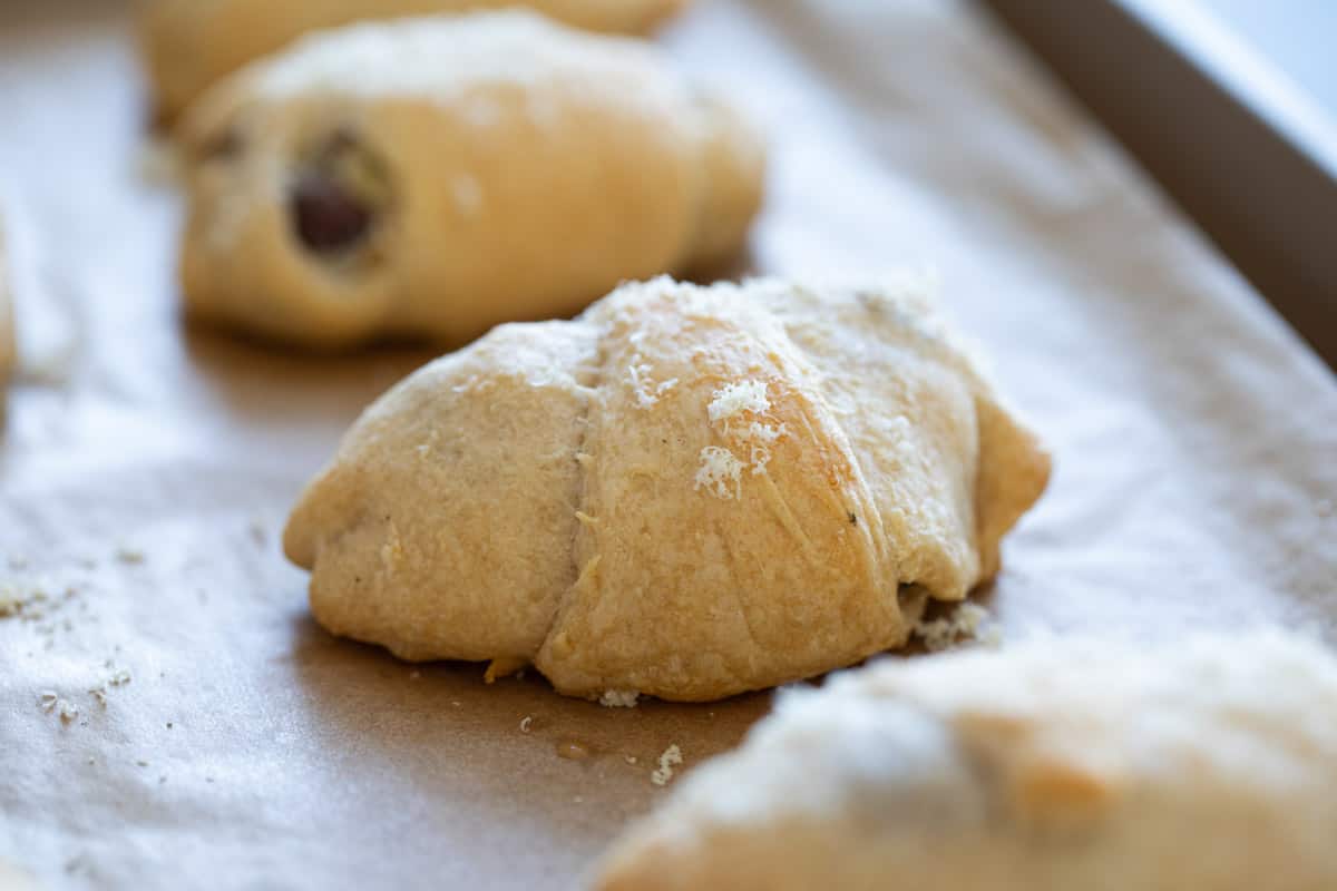 Finished chicken crescent rolls on a baking sheet.