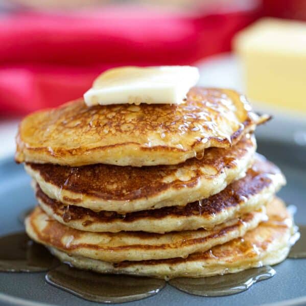 Cornmeal Pancakes stacked on a plate.