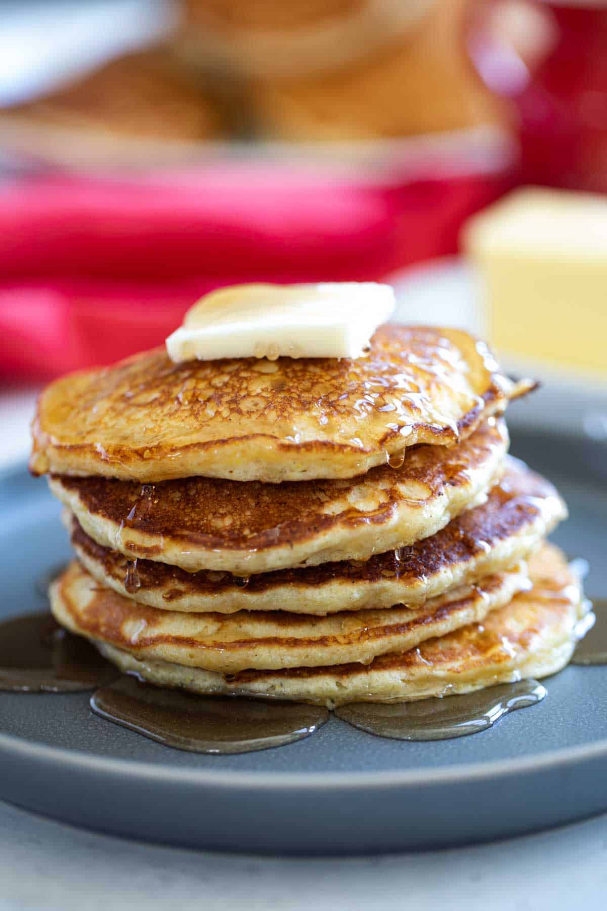 Cornmeal Pancakes stacked on a plate.