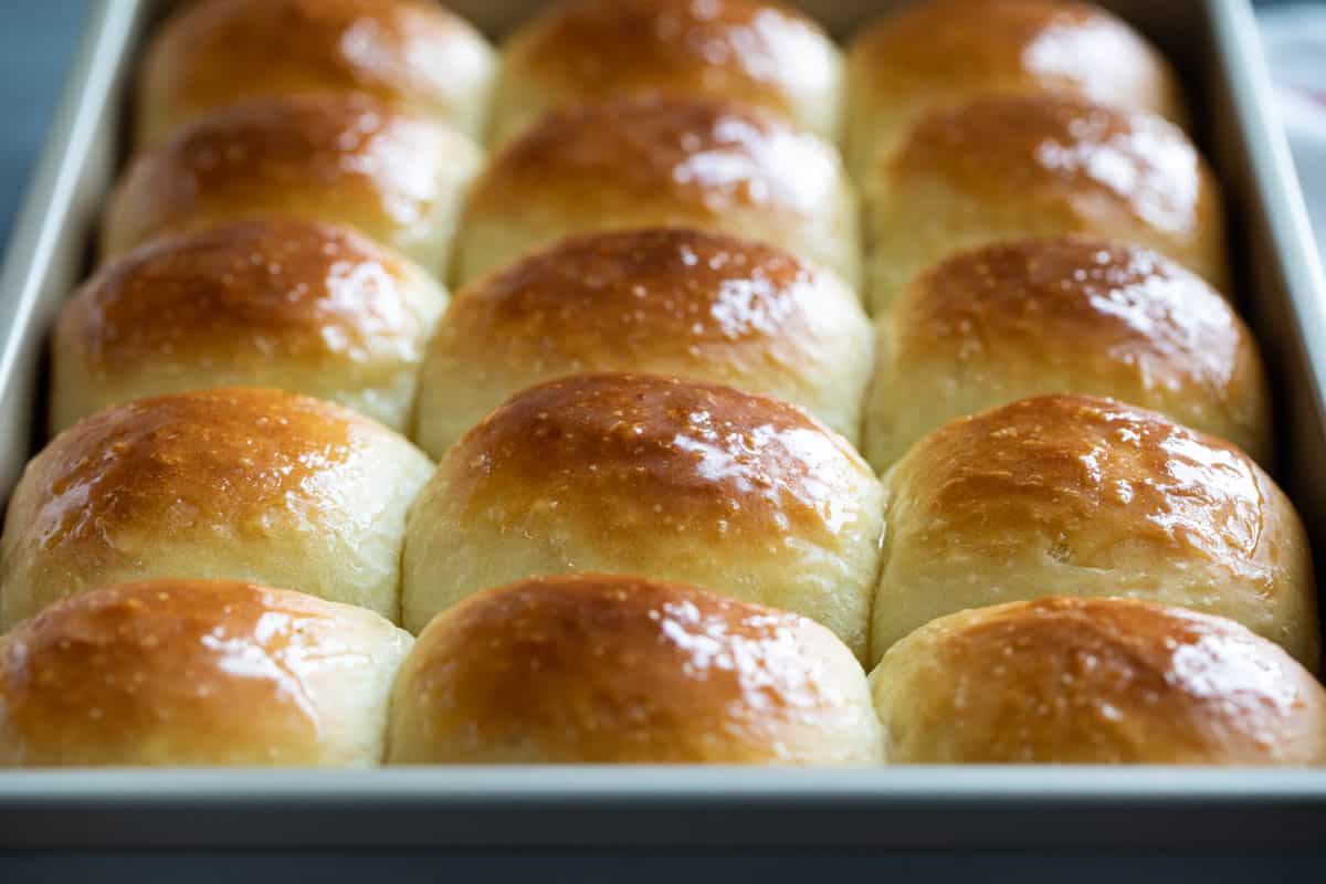 Super soft and buttery, these Potato Rolls are quickly becoming a staple! Mashed potatoes are the secret ingredient that make these rolls super soft for days after they’ve been made. Potato rolls in a baking dish.