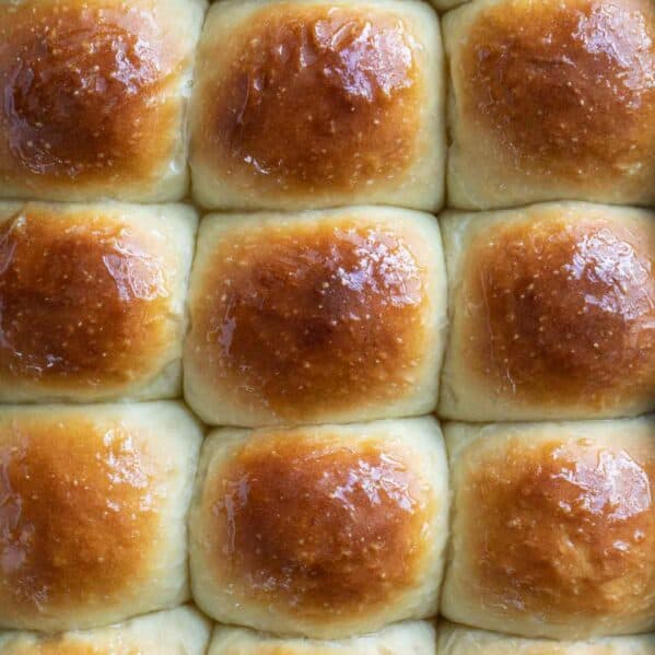 Pan full of browned potato rolls from the top.