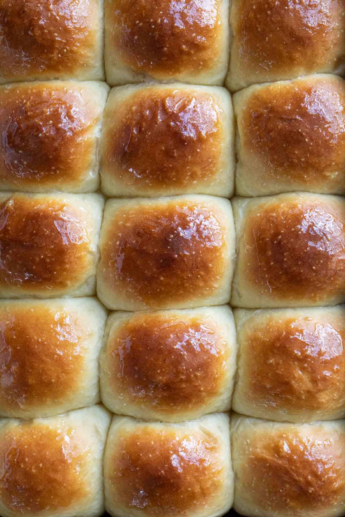 Pan full of browned potato rolls from the top.