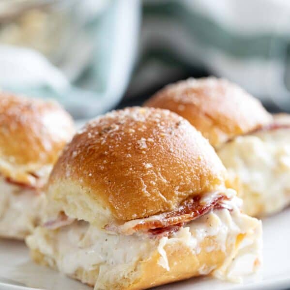 Three chicken bacon ranch sliders on a plate.