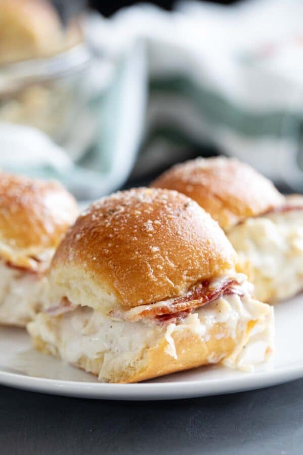 Three chicken bacon ranch sliders on a plate.