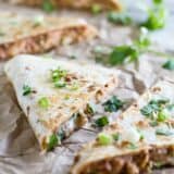 Wedges of chicken quesadilla topped with cilantro.