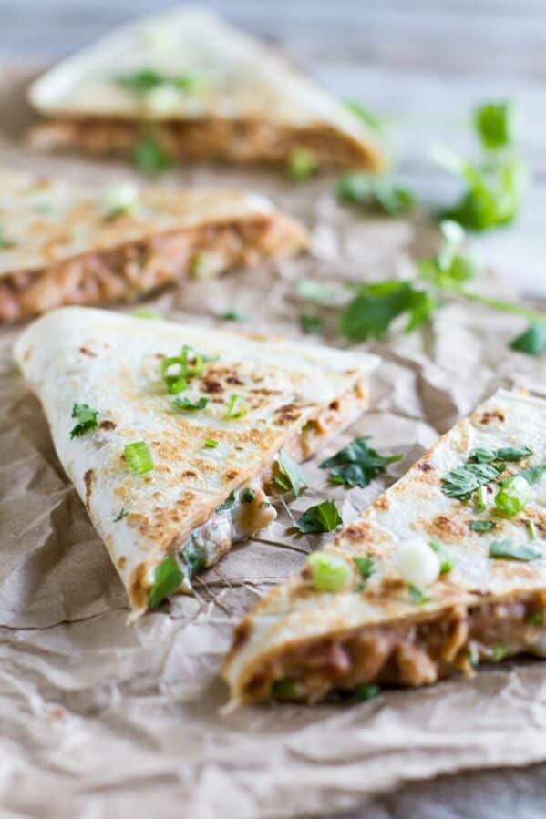 Wedges of chicken quesadilla topped with cilantro.