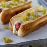 Green Chile Hot Dogs with a green chile sauce and diced green chiles.