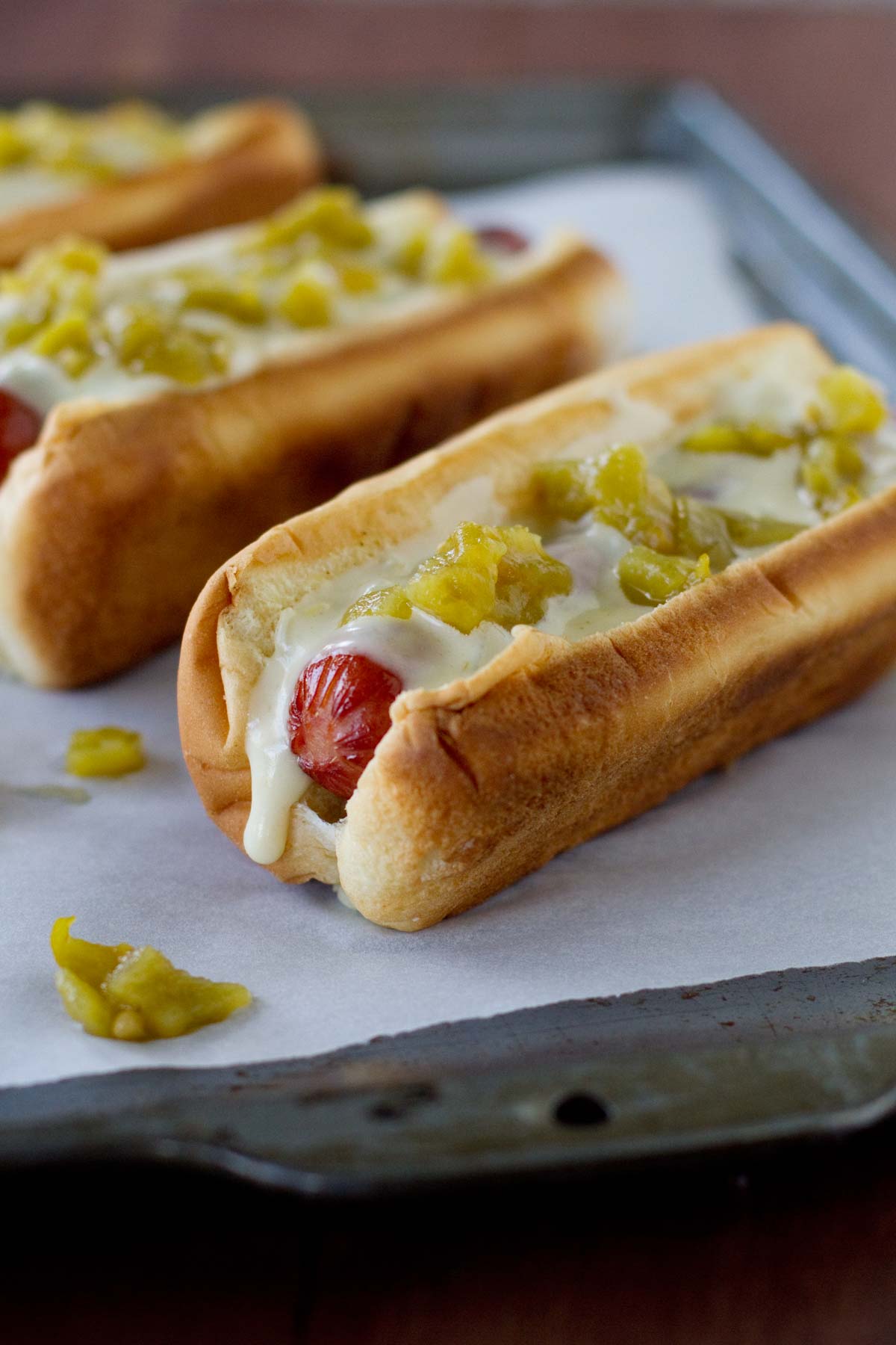 Green Chile Hot Dogs with a green chile sauce and diced green chiles.