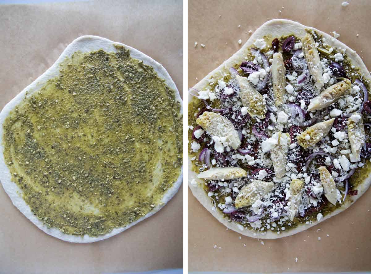 Pizza dough topped with pesto, then with all toppings added.