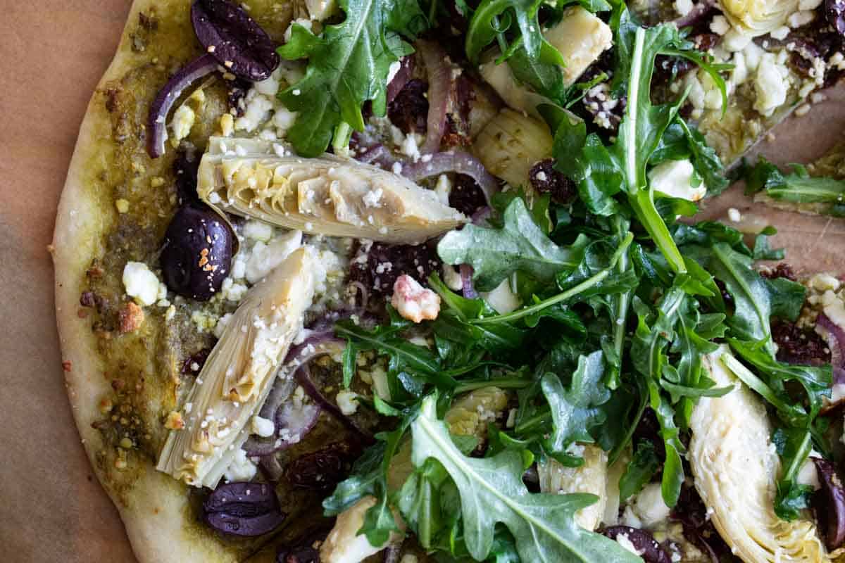 Mediterranean Pizza with arugula on top.
