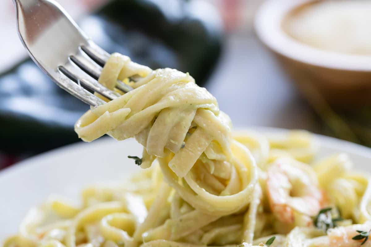 Linguine with poblano cream sauce twirled on a fork.