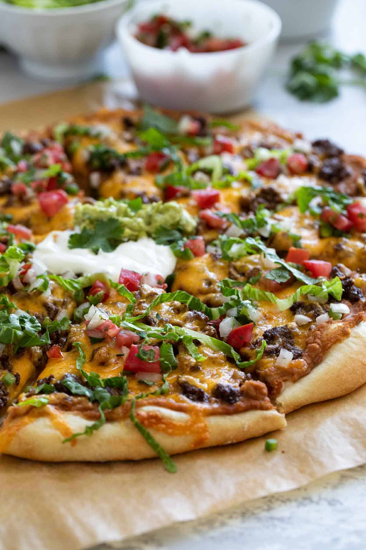 Pizza topped with taco meat, beans, and cheese.