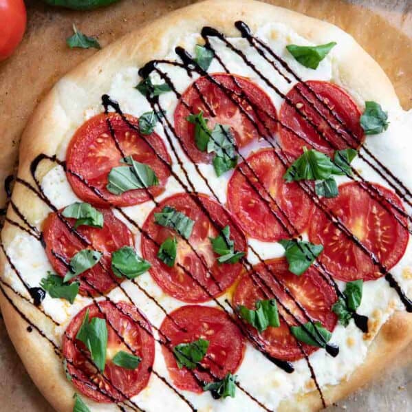 Caprese Pizza with mozzarella, tomatoes, basil, and balsamic glaze.