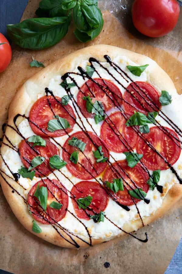 Caprese Pizza with mozzarella, tomatoes, basil, and balsamic glaze.