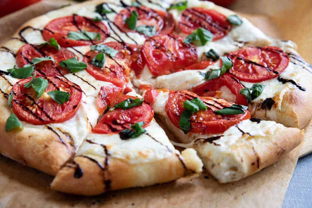Full Caprese Pizza cut into slices.