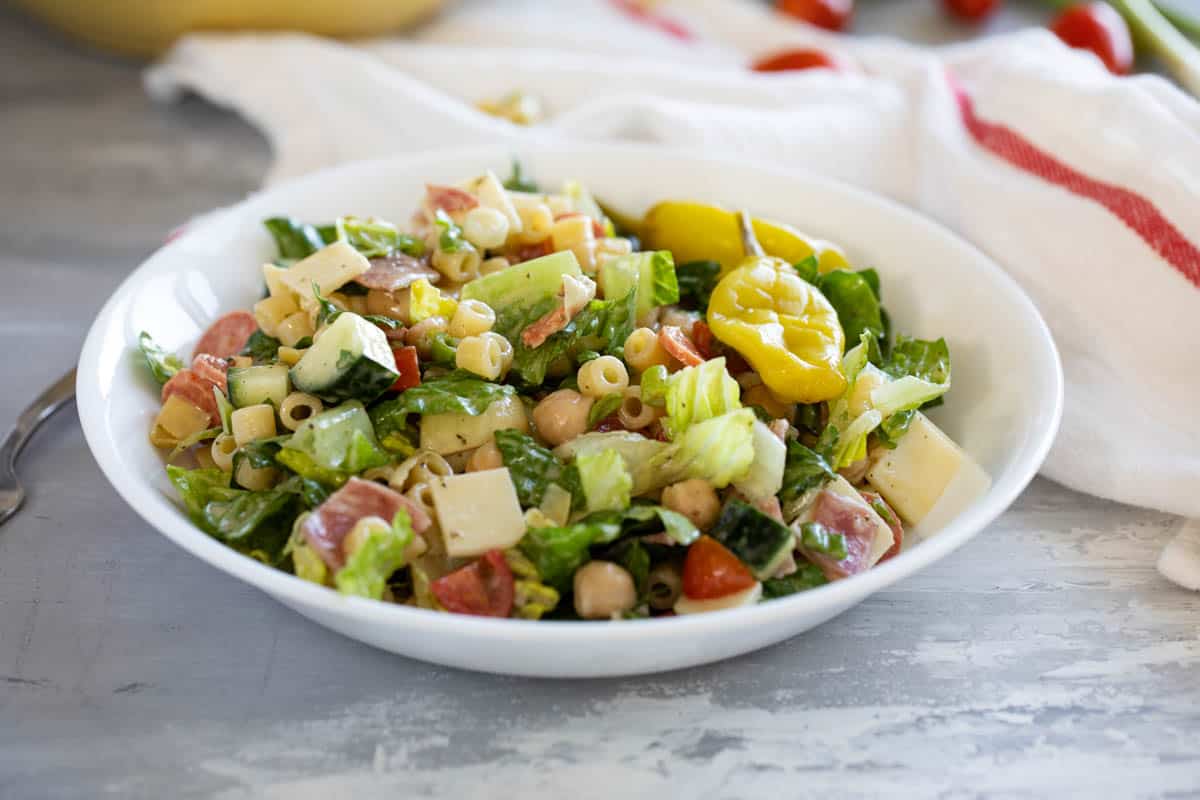 Bowl of Italian Chopped Salad topped with pepperoncini.