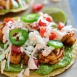 Easy spicy shrimp tostadas with guacamole and a spicy sauce.