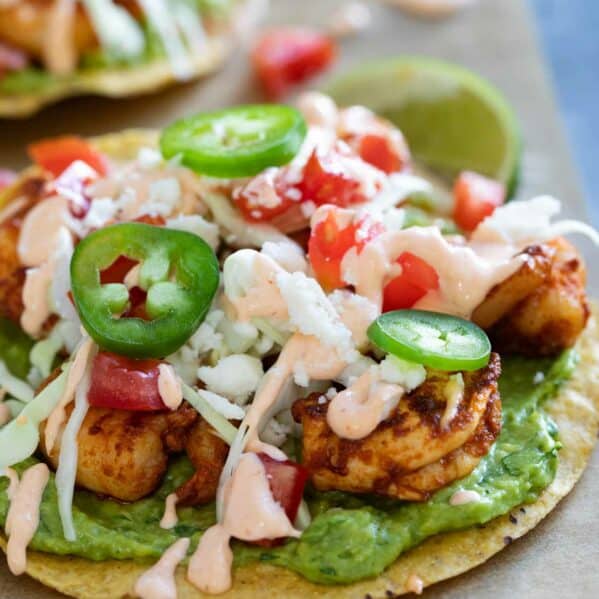 Easy spicy shrimp tostadas with guacamole and a spicy sauce.