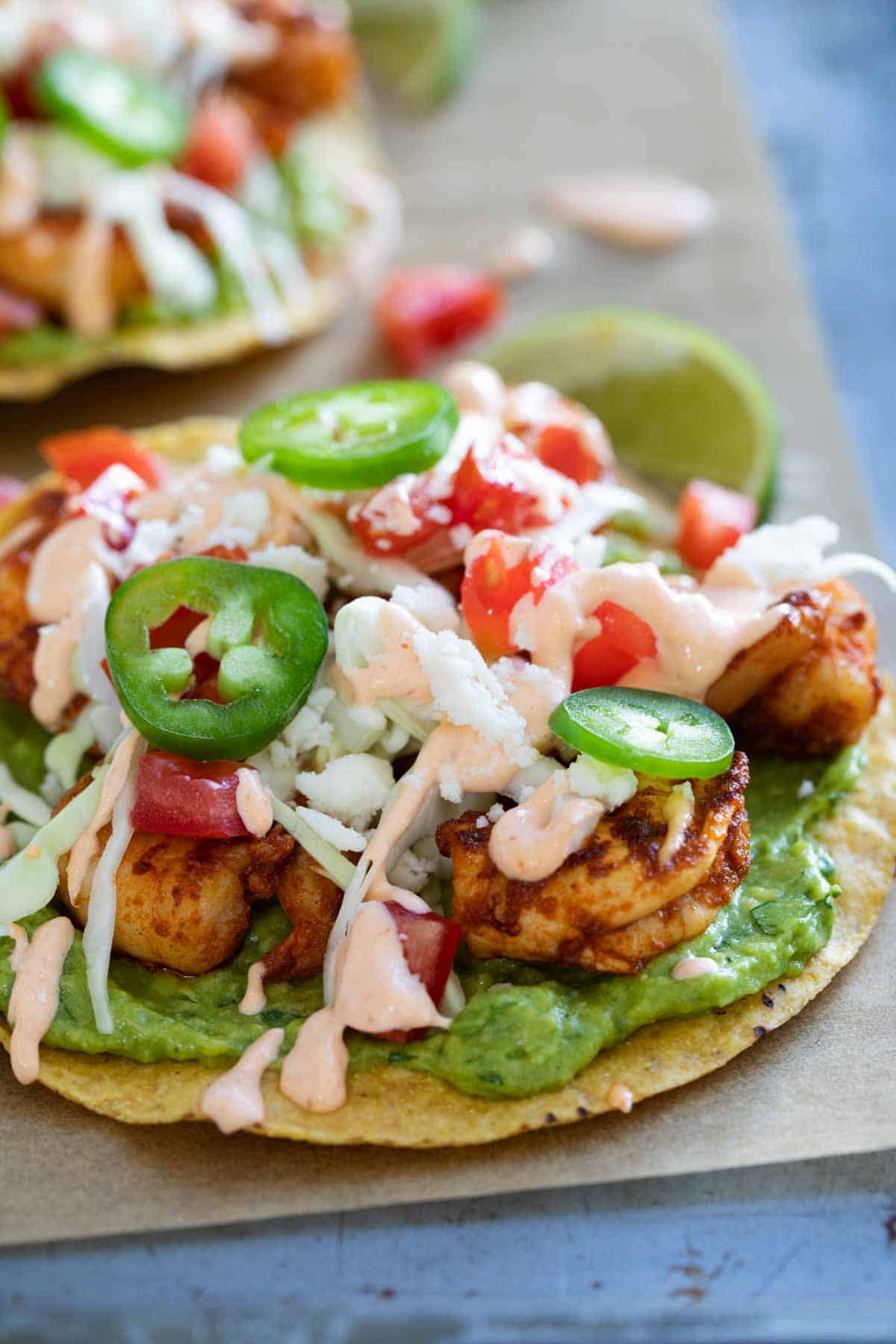 Easy spicy shrimp tostadas with guacamole and a spicy sauce.