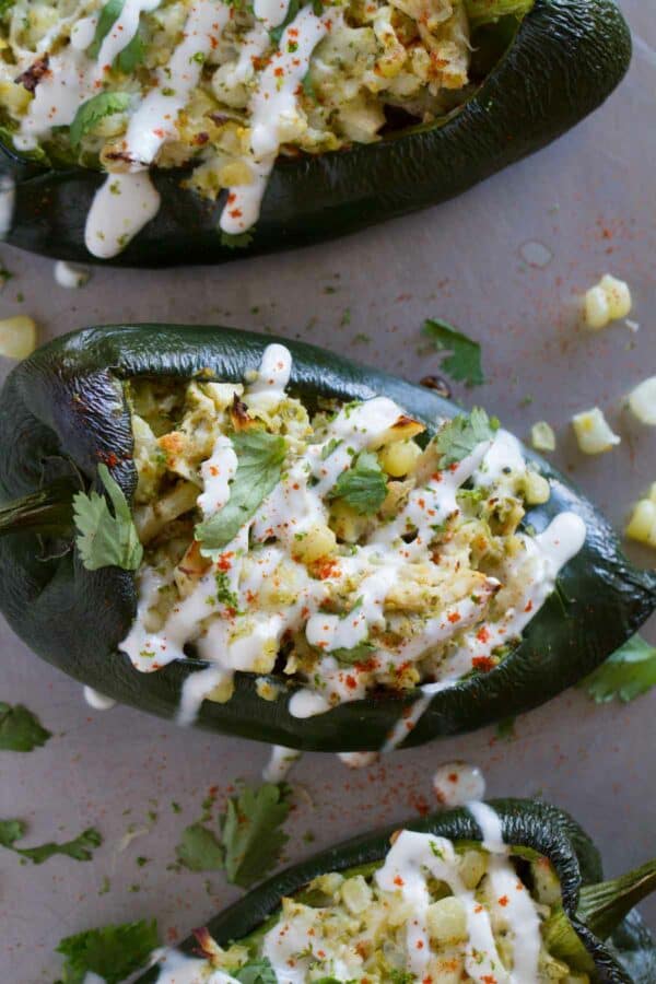 Poblano peppers stuffed with chicken and corn and topped with lime cream.
