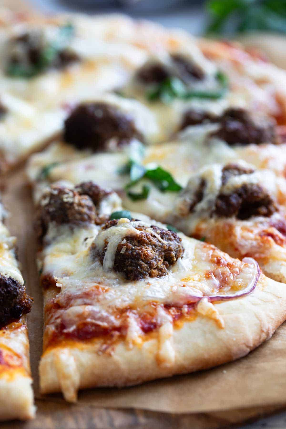 Pizza topped with homemade meatballs.