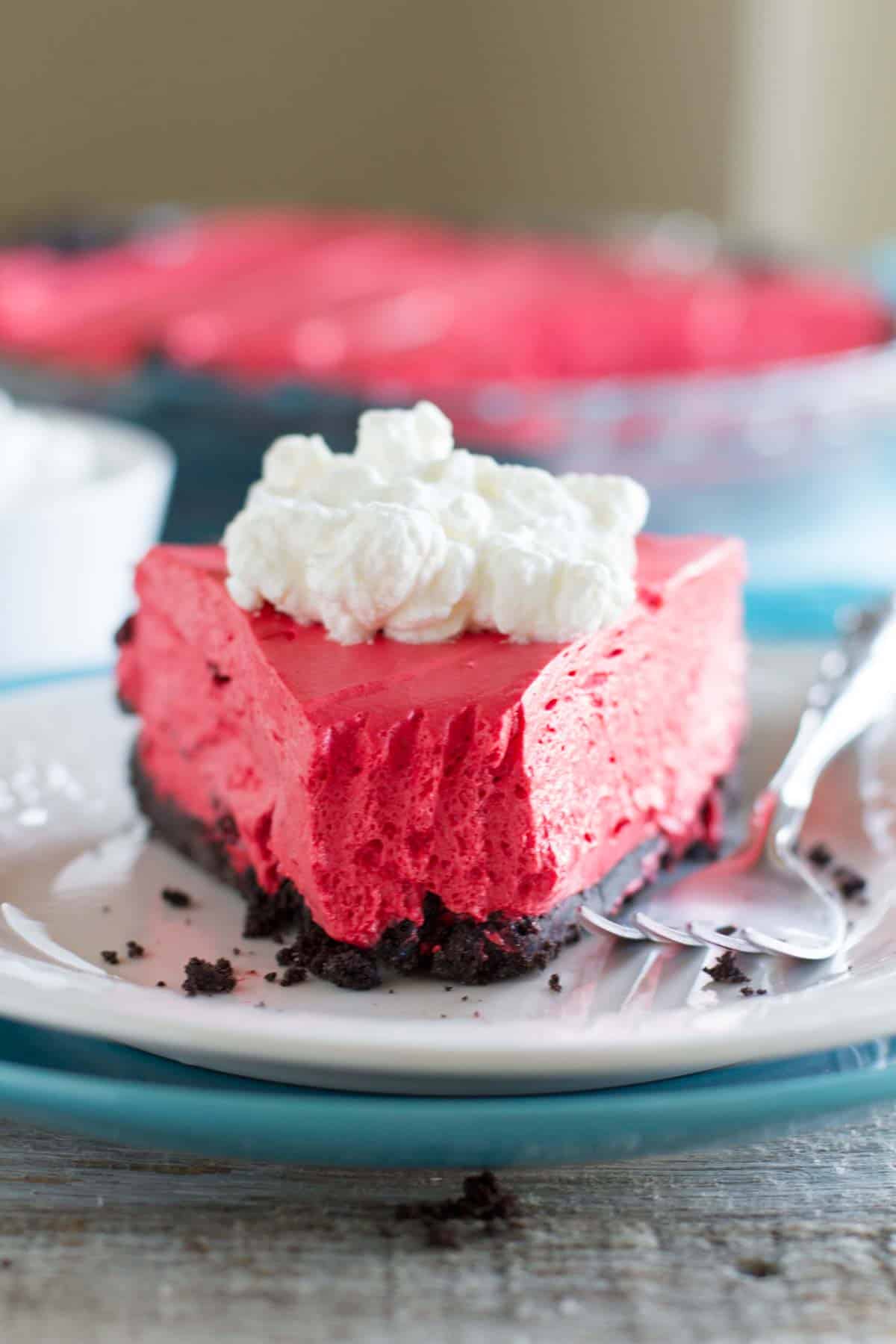 Slice of no bake red velvet cheesecake with a bite taken from it.