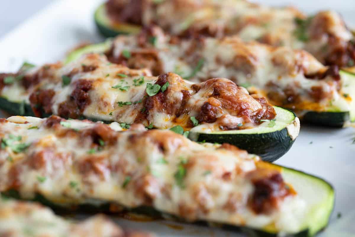 Stuffed Zucchini Boats filled with beef, sausage, and marinara, topped with cheese.