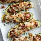 Stuffed Zucchini Boats on a platter topped with parsley.