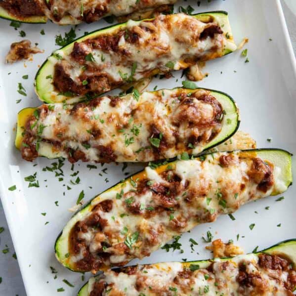 Stuffed Zucchini Boats on a platter topped with parsley.