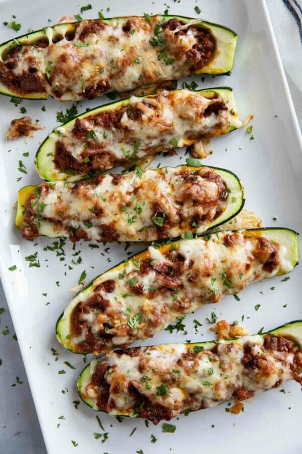 Stuffed Zucchini Boats on a platter topped with parsley.