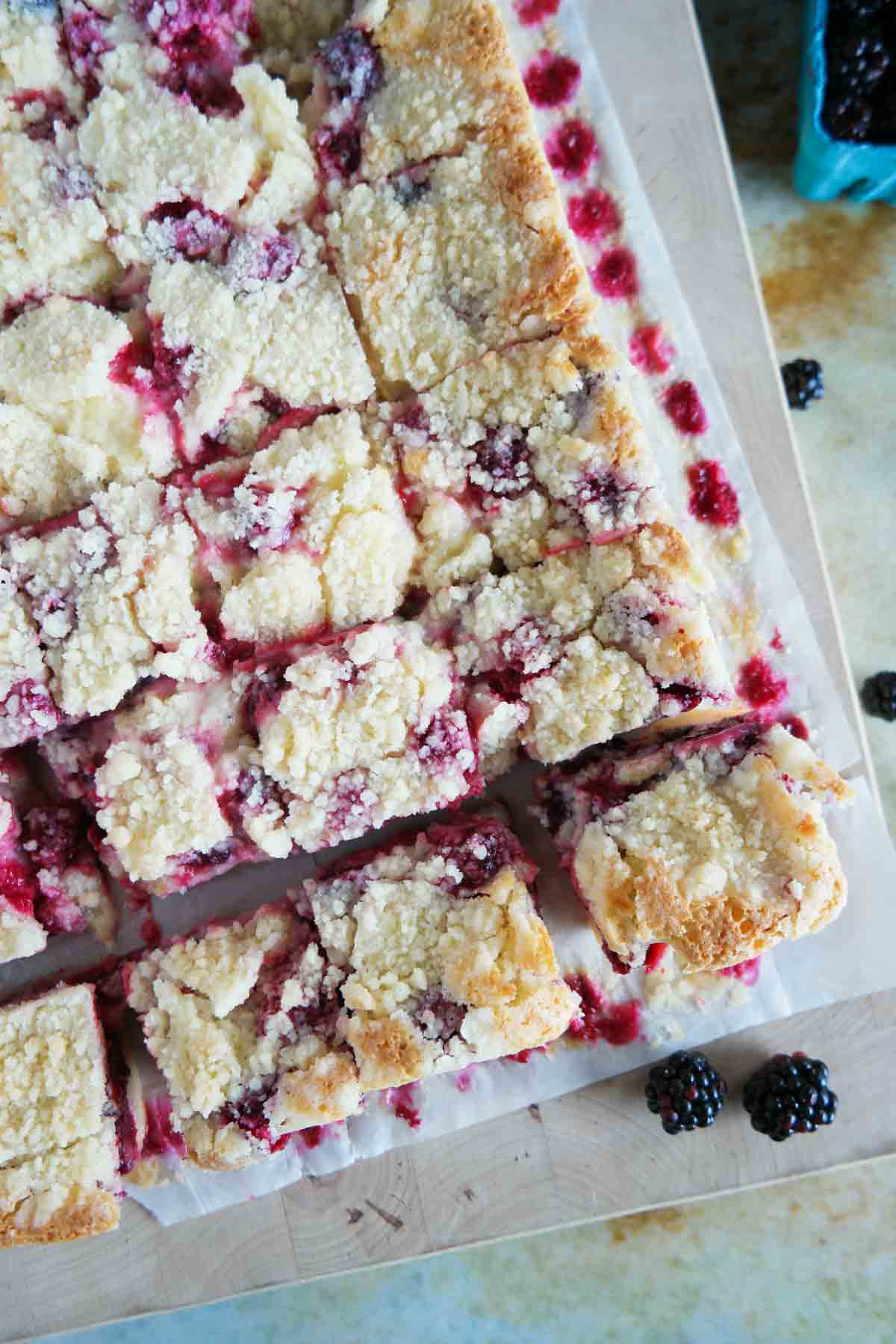 Pan of blackberry pie bars cut into squares.