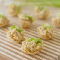 Chicken curry bites on a wooden board for serving.