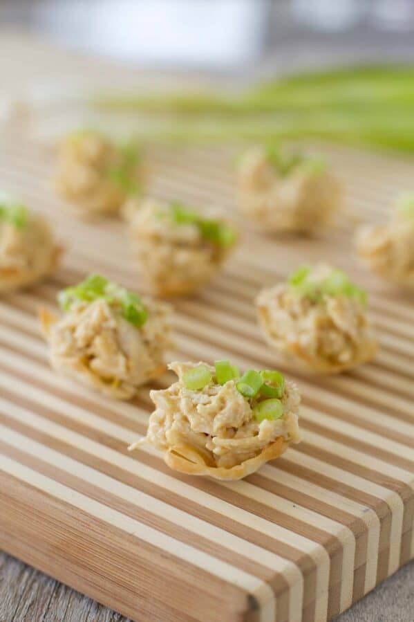 Chicken curry bites on a wooden board for serving.