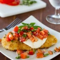 Chicken Margherita - chicken topped with cheese and tomatoes - on a plate.
