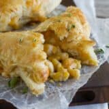 Creamy chicken and corn turnovers with one broken open to see corn filling.