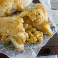Creamy chicken and corn turnovers with one broken open to see corn filling.