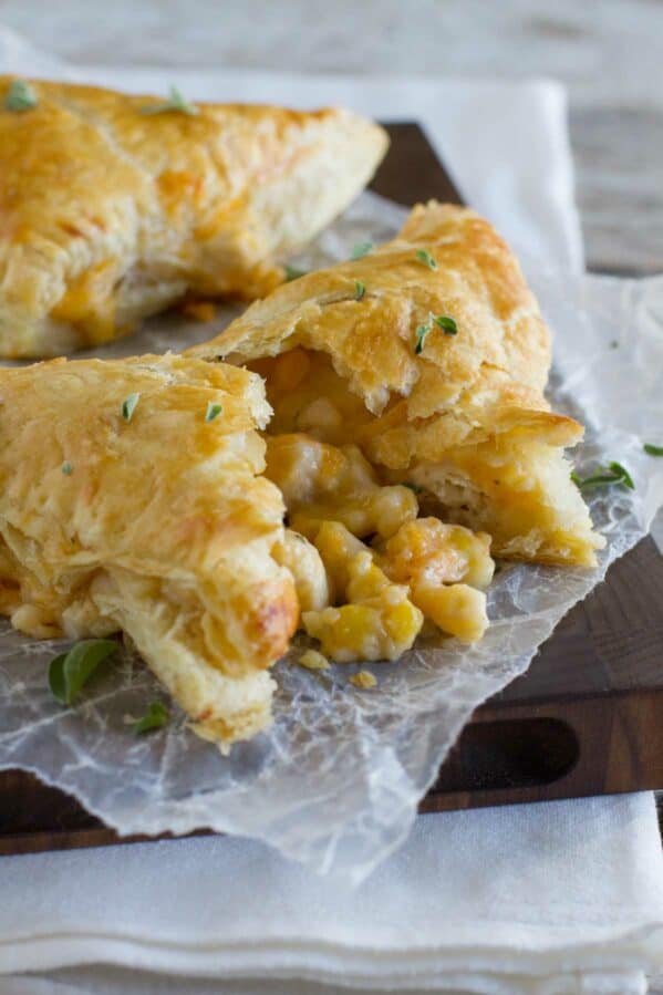 Creamy chicken and corn turnovers with one broken open to see corn filling.