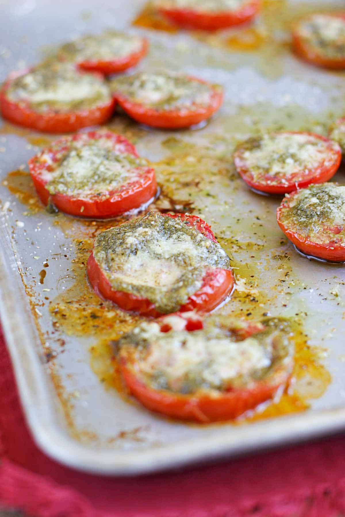 Roasted Tomatoes with Pesto on a baking sheet.