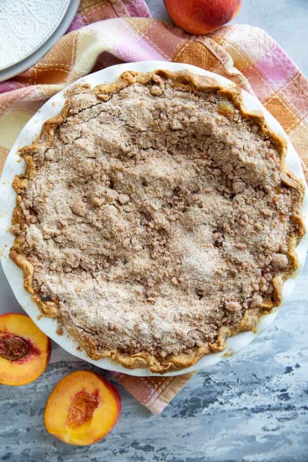 Full sour cream peach pie with a streusel topping.